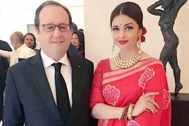 Aishwarya Rai Bachchan (R) greets French President Francois Hollande.