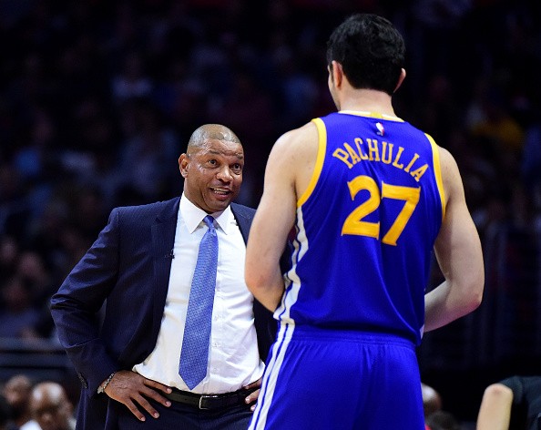 Doc Rivers of the LA Clippers talks with Zaza Pachulia #27 of the Golden State Warriors during a 115-98 Warriors win at Staples Center on December 7, 2016 in Los Angeles, California.  