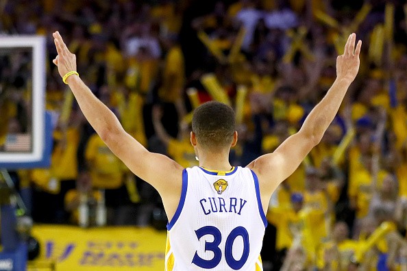 Stephen Curry #30 of the Golden State Warriors reacts after scoring a three-point basket against the Cleveland Cavaliers in Game 7 of the 2016 NBA Finals at ORACLE Arena on June 19, 2016 in Oakland, California. 