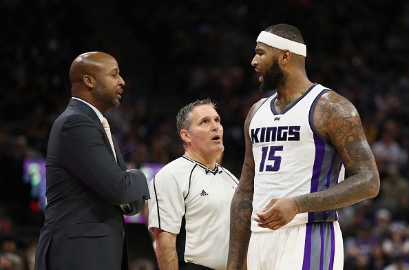 Referee Monty McCutchen stands between Los Angeles Lakers assistant coach Brian Shaw and DeMarcus Cousins #15 of the Sacramento Kings at Golden 1 Center on December 12, 2016 in Sacramento, California. 