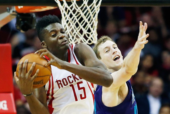 Clint Capela #15 of the Houston Rockets and Cody Zeller #40 of the Charlotte Hornets battle for the basketball during their game at Toyota Center on December 21, 2015 in Houston, Texas. 