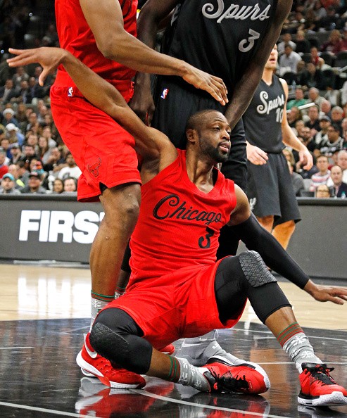 Dwyane Wade #3 of the Chicago Bulls falls to the floor after driving against the San Antonio Spurs at AT&T Center on December 25, 2016 in San Antonio, Texas.  