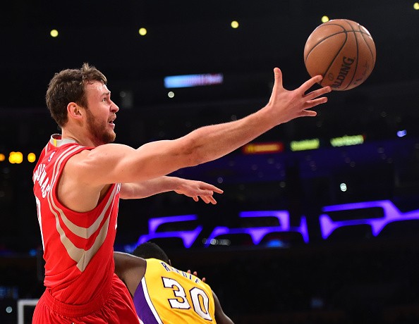 Donatas Motiejunas #20 of the Houston Rockets is fouled as he shoots by Julius Randle #30 of the Los Angeles Lakers during the first half at Staples Center on December 17, 2015 in Los Angeles, California. 