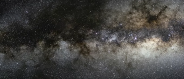 The Milky Way galaxy at night, with a super massive black hole at its center that spits out planetoids from shredded stars.
