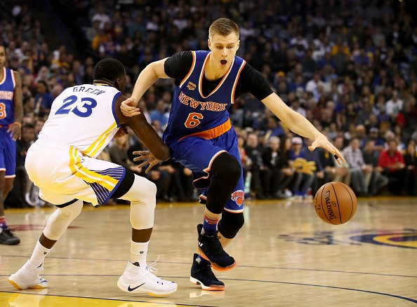 Kristaps Porzingis #6 of the New York Knicks drives on Draymond Green #23 of the Golden State Warriors at ORACLE Arena on December 15, 2016 in Oakland, California. 