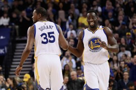 Golden State Warriors players Kevin Durant (L) and Draymond Green