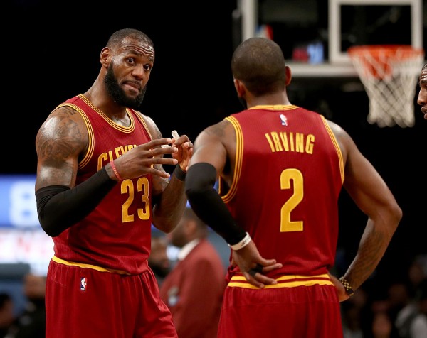 Cleveland Cavaliers players LeBron James (L) and Kyrie Irving