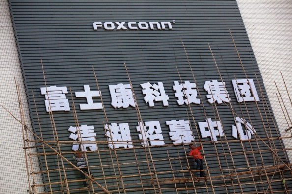Workers put up scaffolding on a building owned by the contract manufacturer Foxconn International Holdings Ltd on November 28, 2010 in Shenzhen, China. 
