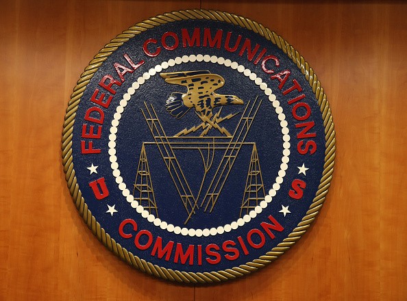The seal of the Federal Communications Commission hangs inside the hearing room at the FCC headquarters February 26, 2015 in Washington, DC.