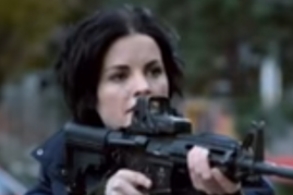 Jane points a gun at someone in a scene from 