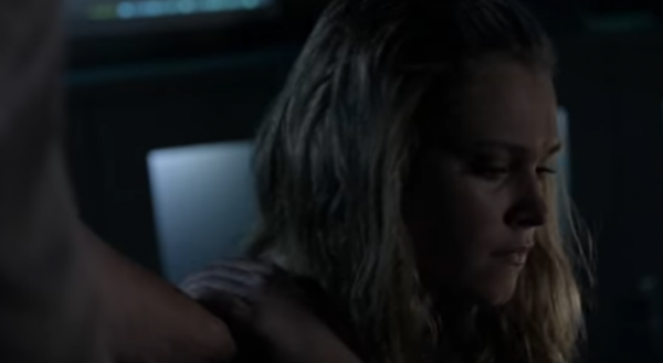 Clarke touches Bellamy's hand on her shoulder in a scene from "The 100" Season 4.