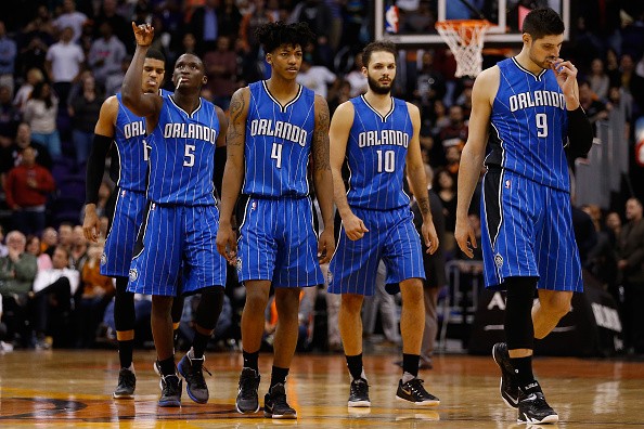 Nikola Vucevic #9, Evan Fournier #10, Elfrid Payton #4 and Victor Oladipo #5 of the Orlando Magic walk to the bench during a break in the final moments of the NBA game against the Phoenix Suns at Talking Stick Resort Arena on December 9, 2015 in Phoenix, 