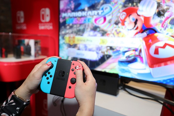 A guest enjoys playing Mario Kart 8 Deluxe on the groundbreaking new Nintendo Switch at a special preview event in New York.
