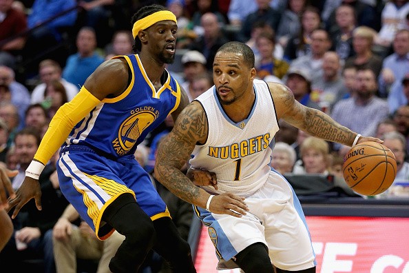 Jameer Nelson #1 of the Denver Nuggets drives against Briante Weber #2 of the Golden State Warriors at the Pepsi Center on February 13, 2017 in Denver, Colorado.