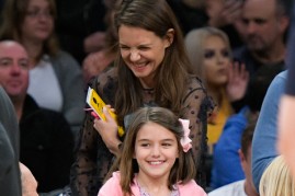 The image depicts Katie Holmes and Suri Cruise. 