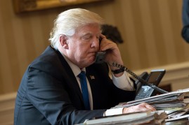President Donald Trump speaks on the phone with Russian President Vladimir Putin in the Oval Office of the White House, Jan. 28, 2017 in Washington, DC. 