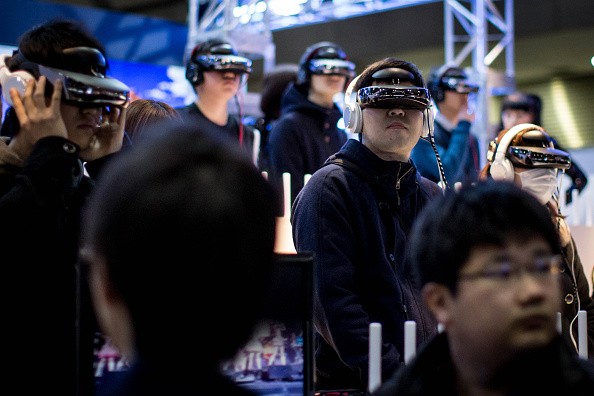 People watch a concert on virtual reality headsets at a booth during the Anime Japan 2015 Expo on March 21, 2015 in Tokyo, Japan. 