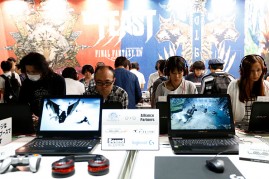 Visitors play the Final Fantasy XIV in the Square Enix Co. booth at Tokyo Game Show on Sept, 17, 2016 in Chiba, Japan. 