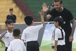 Beckham trains children in the Guangdong province, China.