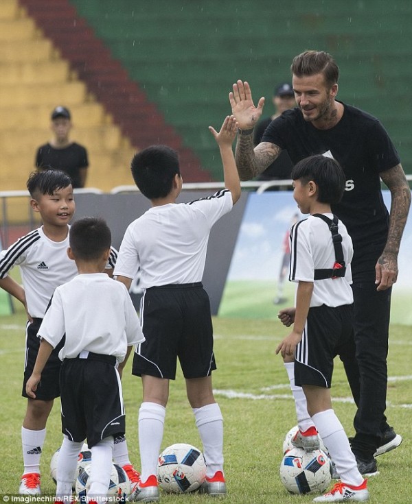 Beckham trains children in the Guangdong province, China.