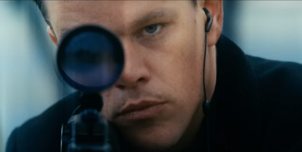Jason Bourne aiming a rifle in a scene from the 2016 movie 'Jason Bourne'.