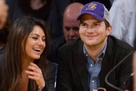 Mila Kunis and Ashton Kutcher watching a live NBA basketball game