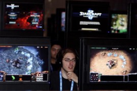 Visitors play at the 'Starcraft' stand of U.S. video game company Blizzard Entertainment during the 'gamescom', Europe's biggest trade fair for interactive games and entertainment on August 19, 2009 in Cologne, Germany.