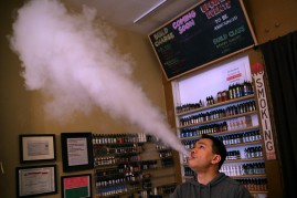Christopher Chin blows vapor from an e-cigarette at Gone With the Smoke Vapor Lounge on May 5, 2016 in San Francisco, California. 