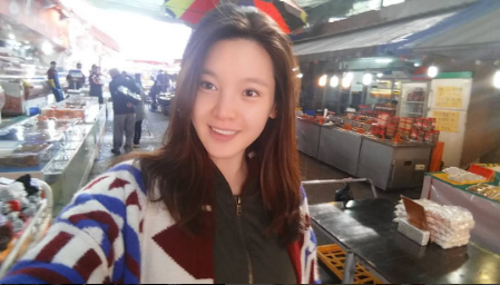 Actress Jung Ga Eun walking around a market in Busan.