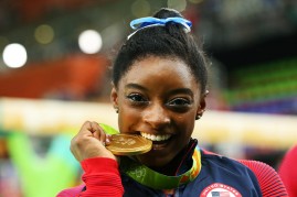 Gold medalist Simone Biles of the United States poses for photographs.