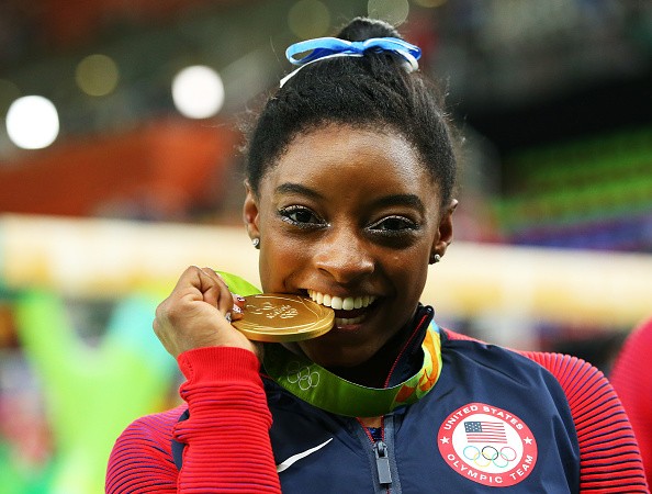 Gold medalist Simone Biles of the United States poses for photographs.