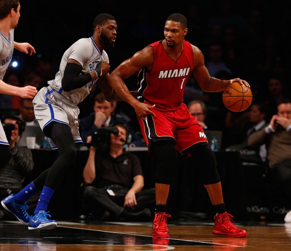 Miami Heat power forward Chris Bosh (R) posts up against Brooklyn Nets' Willie Reed