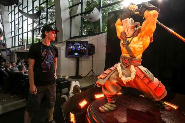  A fan dressed in limited edition DOTA 2 merchandise poses for a photo at The International DOTA 2 Champsionships at Key Arena.