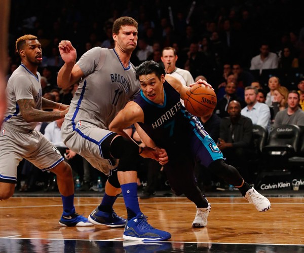 Brooklyn Nets center Brook Lopez (L) defends against former Charlotte Hornets point guard and now teammate Jeremy Lin